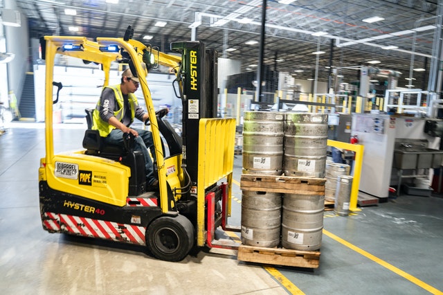 A forklift machine carrying cans