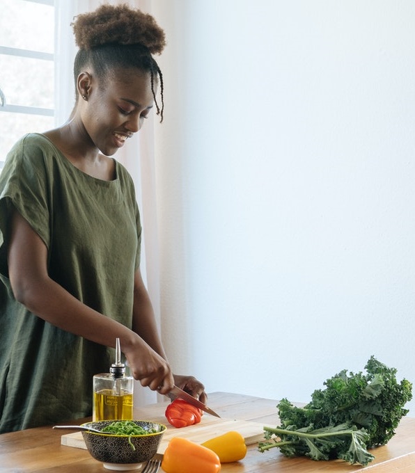 A happy lady preparing food at home. 