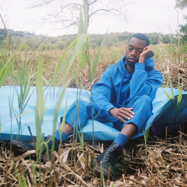 a young farmer in a blue-pullover-hoodie-