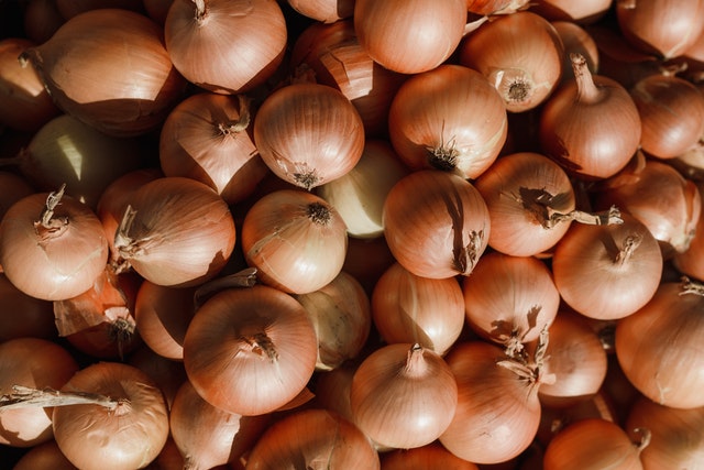 dry onions displayed in market