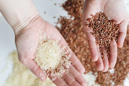 a shopper examining brown and white rice