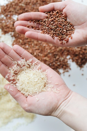 a shopper examining brown and white rice