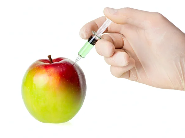 Green apple receiving an injection for rapid ripening