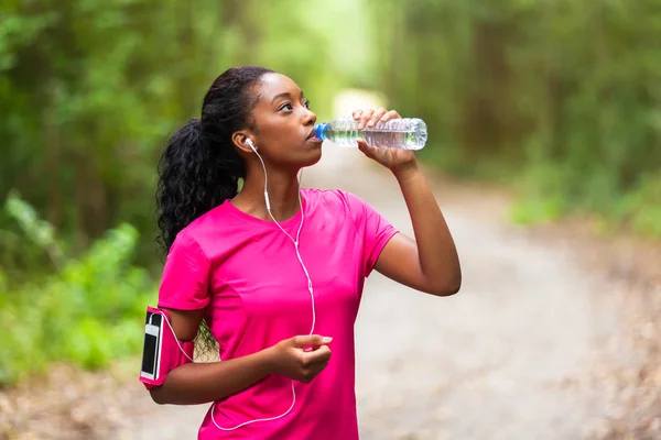 African american woman jogger drinking water