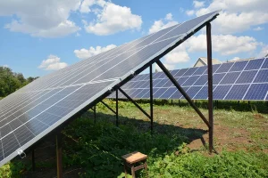 Solar panels with beautiful clouds sky in the garden. Backyard solar panels for energy efficiency
